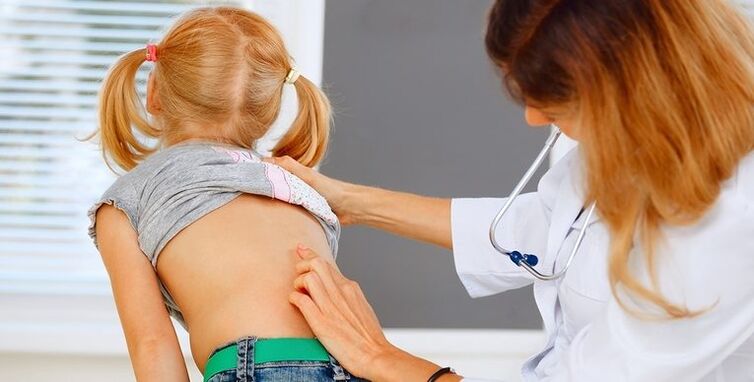 A doctor examines a child's back for lower back pain